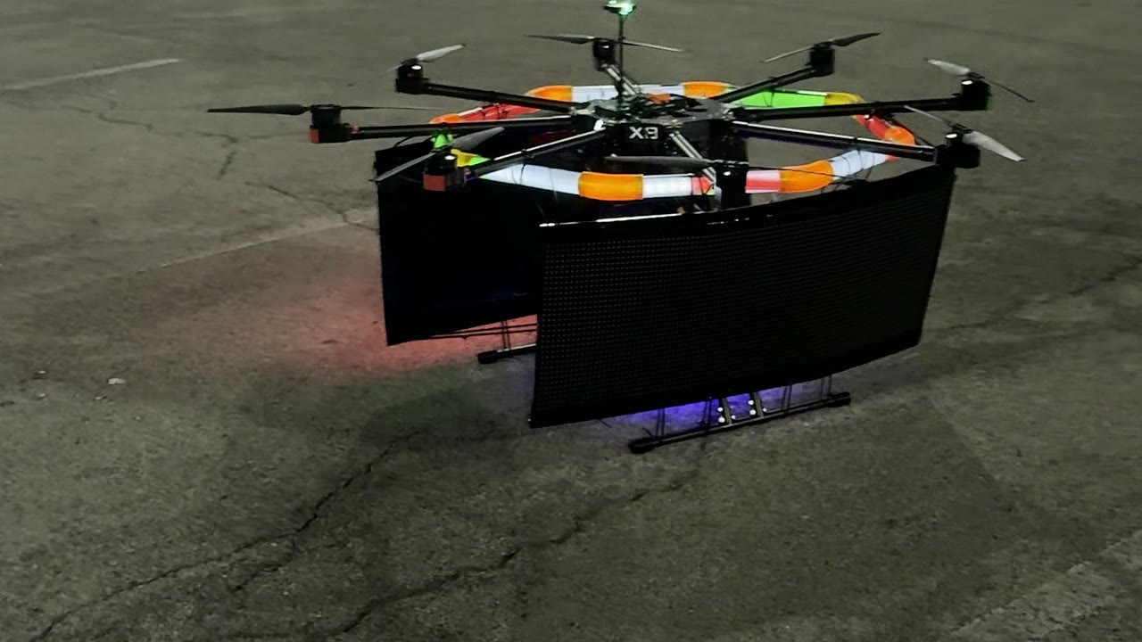 Large close view of the Aerial GraphX aircraft, rotors, LED frame, and display panels